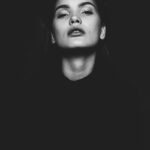 black and white photo of woman looking upward