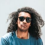 man wearing blue shirt and black lens sunglasses